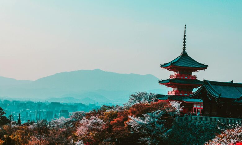 red and black temple surrounded by trees photo